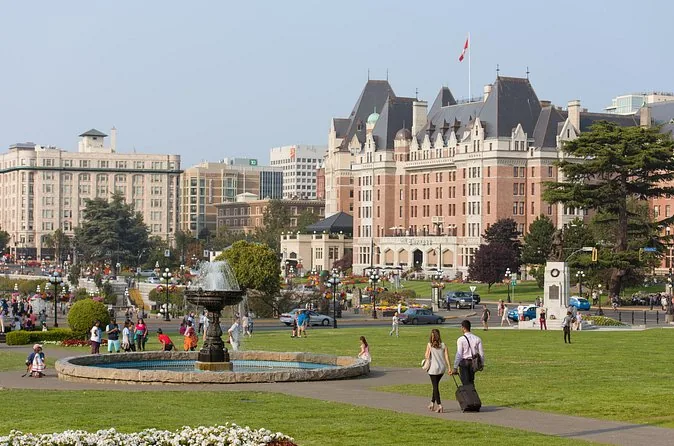 The Fairmont Empress hotel above a fountain and lawn by Victoria's Inner Harbour
